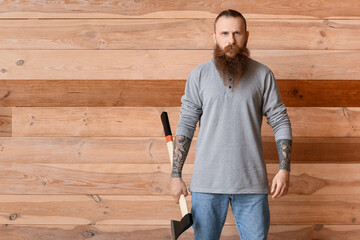 Handsome lumberjack on wooden background