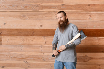 Handsome lumberjack on wooden background