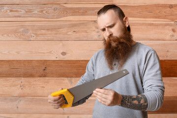 Handsome lumberjack on wooden background