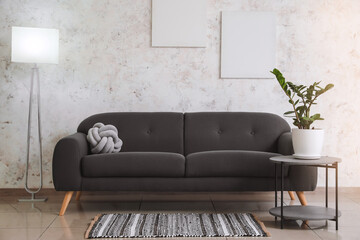 Interior of room with modern lamp, sofa and table