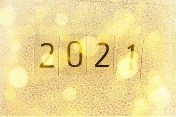 2021 on a gold shiny textured paper background