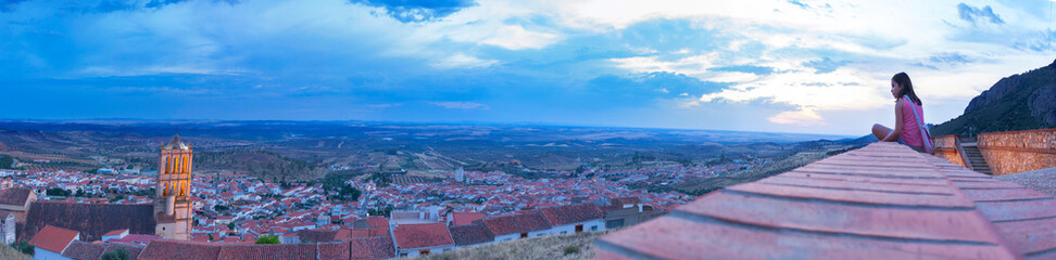 Child girl enjoying Tierra de barros panoramic dusk from viewpoint, Hornachos, Spain