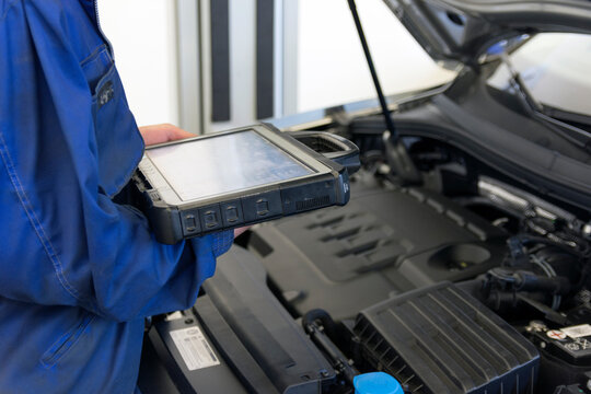 Electrical diagnostics of a car. A mechanic diagnoses a car in a car service.	