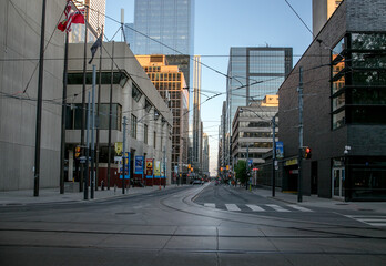 Toronto, Ontario/Canada - 05 26 2020 - Empty street without people. Quarantine city Toronto buildings, skyscraper, downtown. Evening time, sunset 