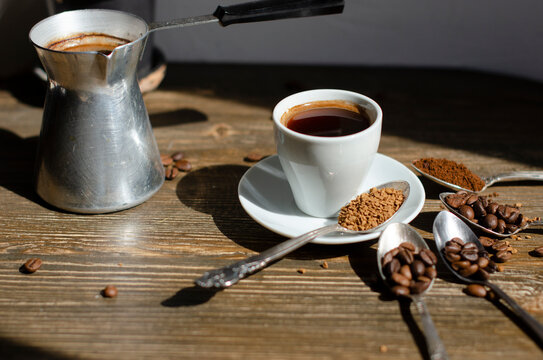 a cup of coffee on the table with different types of kefe in spoons