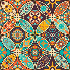 Seamless colorful patchwork tile with Islam, Arabic, Indian, Ottoman motifs. Majolica pottery tile. Portuguese and Spain decor. Azulejo. Ceramic tile in talavera style. Boho pattern