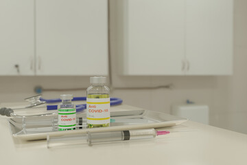 3D illustration of Anti COVID-19 vaccine and syringe in a clinic