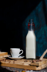 cup of coffee with milk on wooden background