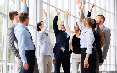 corporate and teamwork concept - happy business team making high five or celebrating success at...