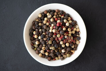 spices for cooking - black, white and red pepper peas close-up