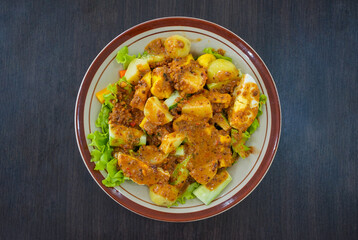 Gado-Gado. Traditional Indonesian cuisine served with peanut sauce with a tang of tamarind, sweetness of palm sugar, and a kick of chili. Composition: lettuce, potato, cucumber, carrot and boiled eggs
