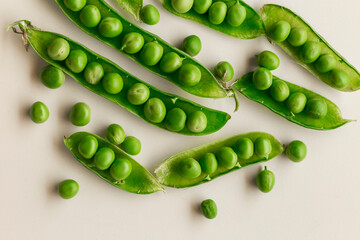 Green fresh peas ans pea pods isolated on white top view.