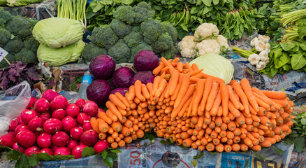 Istanbul, Turkey  May 31, 2016 - Carrots, radishes, onions and other vegetables are on display at a local market