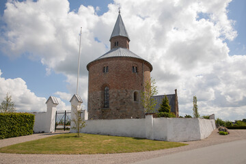 Fototapeta na wymiar Old round church with blue sky and clouds 