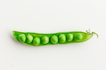 Green fresh peas ans pea pods isolated on white top view.