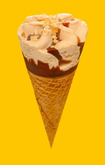 angle view milk tea flavor ice cream cone on a yellow background