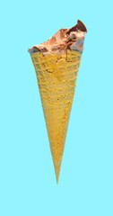 side view fresh chocolate flavor ice cream cone with some bites on a blue background
