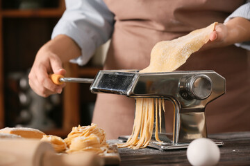 Woman preparing pasta in kitchen, closeup