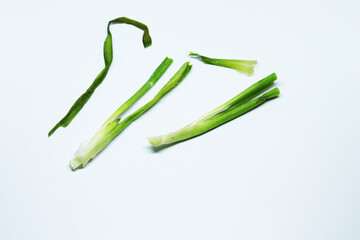 Fresh Green Spring Onion With Roots On An Isolated White Background