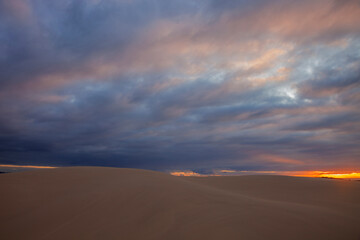 Fototapeta na wymiar Colourful clouds over sand dunes at Myall Lakes National Park.East Coast of N.S.W. Australia.