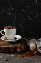 coffee beans in a small white cup. sprinkled coffee beans