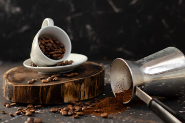 coffee beans in a small white cup. sprinkled coffee beans