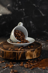 coffee beans in a small white cup. sprinkled coffee beans