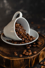 coffee beans in a small white cup. sprinkled coffee beans