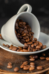 coffee beans in a small white cup. sprinkled coffee beans
