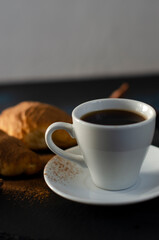 cup of coffee with chocolate croissants on the table