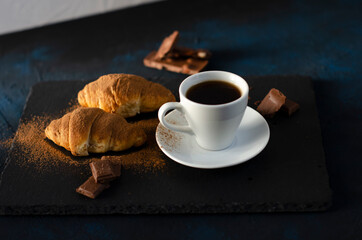 cup of coffee with chocolate croissants on the table