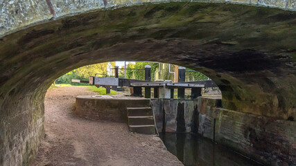 Looking under a bridge on a canal at the lock gates