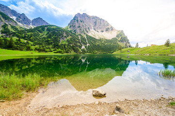 Naklejka na ściany i meble Beautiful landscape scenery of the Gaisalpsee and Rubihorn Mountain at Oberstdorf, Reflection in Mountain Lake, Allgau Alps, Bavaria, Germany