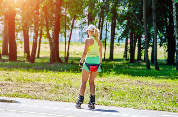 Girl roller skating in the summer Park
