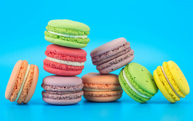 Cake macaroons on a blue background. Colorful almond cookies.