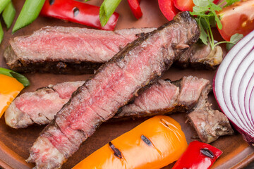 Sliced grilled marbled beef steak in plate.