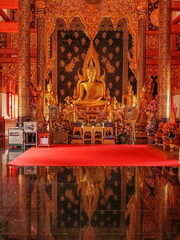 Fototapeta na wymiar view of Golden buddha statue in buddhist temple, Wat Phra That Suthon Mongkhon Khiri, Denchai District, Phrae Province, northern of Thailand.