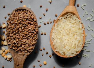 rice, buckwheat, peas in wooden spoons are on the table