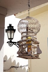 Metal birdcage and wrought iron lantern, Benahavis, Spain.