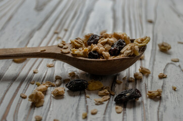 wooden spoon with granola on the table