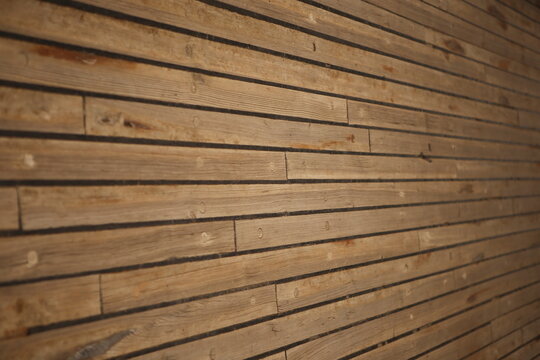 close up filled frame background wallpaper photo of yellow brown wooden planks with vertical lines on a deck of ship