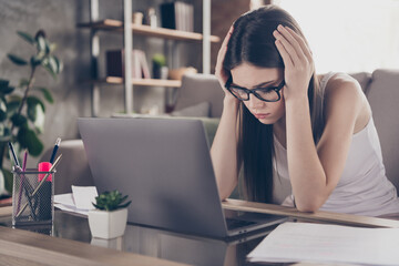 Portrait of frustrated exhausted girl manager touch hands head feel migraine work remote laptop...