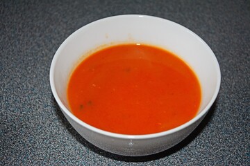 Homemade tomato soup in a white dish, UK.