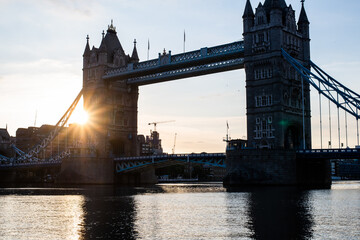 Tower Bridge at Sunrise in Summer,  with the sun shining through it