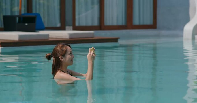 Woman take photo on swimming pool