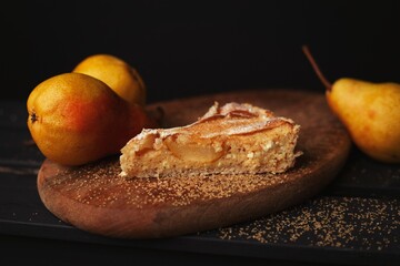 Tasty homemade pear pie on wooden background