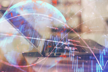 Forex graph hologram on table with computer background. Double exposure. Concept of financial markets.