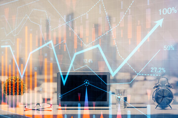 Forex graph hologram on table with computer background. Multi exposure. Concept of financial markets.