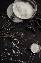 sieve with flour on a black background and nimbuses