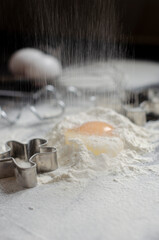 Fototapeta na wymiar ingredients for cookies. broken eggs uphill with flour